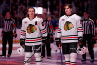 Mar 24, 2026; Elmont, New York, USA; Chicago Blackhawks centers Connor Bedard (98) and Anton Frondell (15) stand for the US national anthem before a game against the New York Islanders at UBS Arena. Mandatory Credit: Brad Penner-Imagn Images