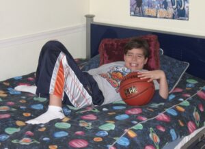 Luka laying on his childhood bed. 