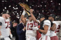 Jan 8, 2018; Atlanta, GA, USA; Alabama Crimson Tide quarterback Tua Tagovailoa (13) holds up the trophy after the win over the Georgia Bulldogs in the 2018 CFP national championship college football game at Mercedes-Benz Stadium.