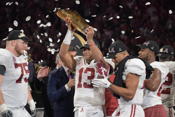 Jan 8, 2018; Atlanta, GA, USA; Alabama Crimson Tide quarterback Tua Tagovailoa (13) holds up the trophy after the win over the Georgia Bulldogs in the 2018 CFP national championship college football game at Mercedes-Benz Stadium.