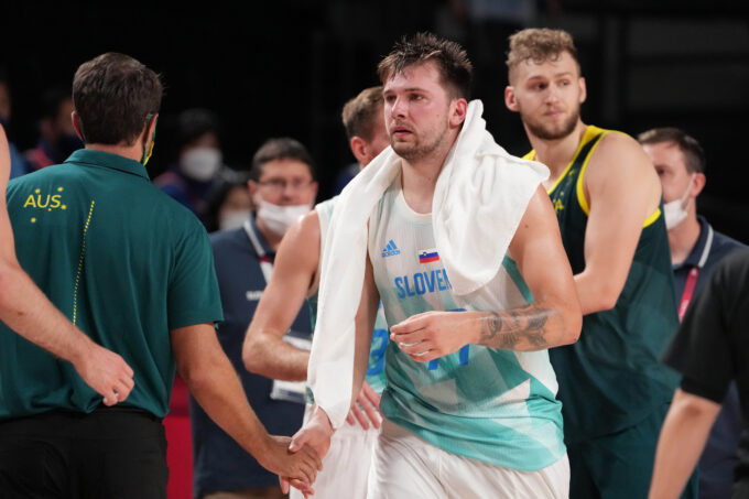 Aug 7, 2021; Saitama, Japan; Team Slovenia point guard Luka Doncic (77) shakes hands with Australia players and coaches after their game during the Tokyo 2020 Olympic Summer Games at Saitama Super Arena. Mandatory Credit: Kyle Terada-USA TODAY Sports