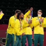Aug 7, 2021; Saitama, Japan; Team Australia point guard Patty Mills (5) celebrates with teammates after winning the bronze medal against the Slovenia during the Tokyo 2020 Olympic Summer Games at Saitama Super Arena. Mandatory Credit: Kyle Terada-USA TODAY Sports