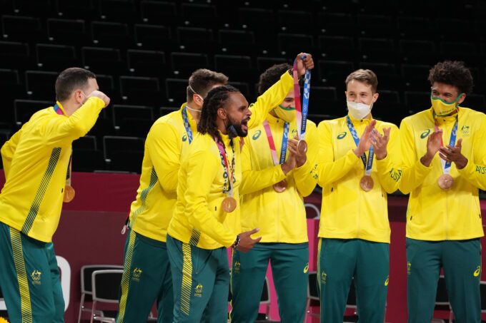Aug 7, 2021; Saitama, Japan; Team Australia point guard Patty Mills (5) celebrates with teammates after winning the bronze medal against the Slovenia during the Tokyo 2020 Olympic Summer Games at Saitama Super Arena. Mandatory Credit: Kyle Terada-USA TODAY Sports