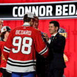 Jun 28, 2023; Nashville, Tennessee, USA; Chicago Blackhawks general manager Kyle Davidson congratulates first overall pick Connor Bedard during the 2023 NHL Draft at Bridgestone Arena. Mandatory Credit: