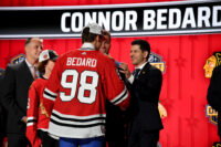 Jun 28, 2023; Nashville, Tennessee, USA; Chicago Blackhawks general manager Kyle Davidson congratulates first overall pick Connor Bedard during the 2023 NHL Draft at Bridgestone Arena. Mandatory Credit: