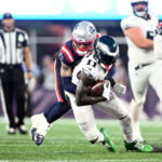 Sep 10, 2023; Foxborough, Massachusetts, USA; Philadelphia Eagles wide receiver A.J. Brown (11) is tackled by New England Patriots cornerback Christian Gonzalez (6) during the second half at Gillette Stadium. Mandatory Credit: Brian Fluharty-USA TODAY Sports