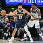 Jan 25, 2025; Minneapolis, Minnesota, USA; Denver Nuggets guard Jamal Murray (27) is defended by Minnesota Timberwolves guard Anthony Edwards (5) during the third quarter at Target Center. Mandatory Credit: Jeffrey Becker-Imagn Images
