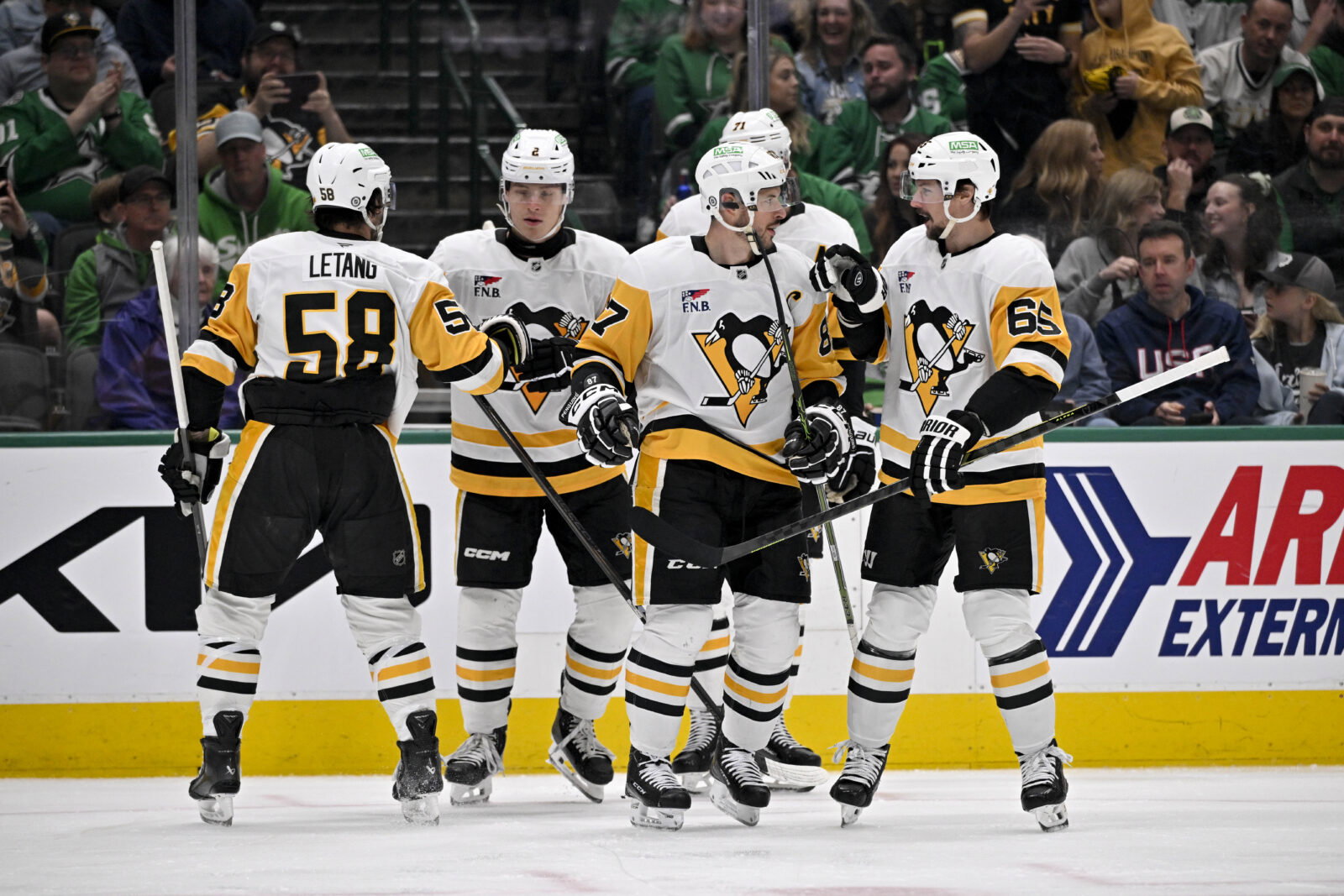 Apr 5, 2025; Dallas, Texas, USA; Pittsburgh Penguins defenseman Kris Letang (58) and right wing Rutger McGroarty (2) and center Evgeni Malkin (71) and defenseman Erik Karlsson (65) celebrate after Penguins center Sidney Crosby (87)