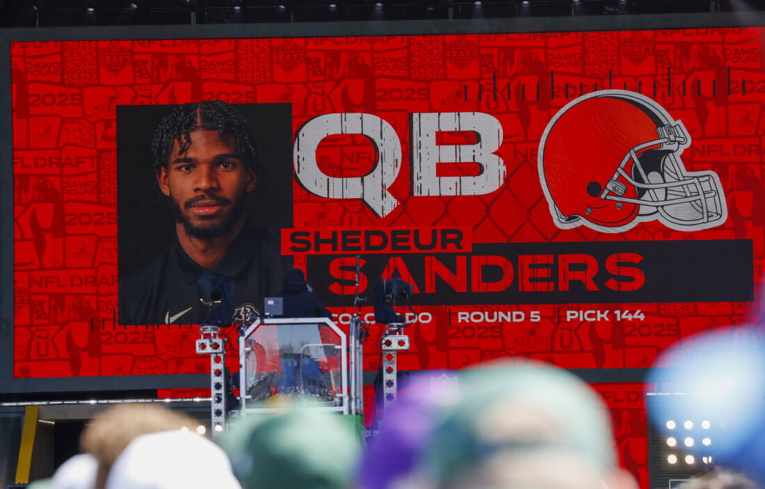 Apr 25, 2025; Green Bay, WI, USA; A graphic announcing Colorado quarterback Shedeur Sanders’ selection by the Cleveland Browns with the 144th overall pick is seen in the Draft Theater during the third day of the 2025 NFL Draft at Lambeau Field. Mandatory Credit: Tork Mason/USA Today Network via Imagn Images