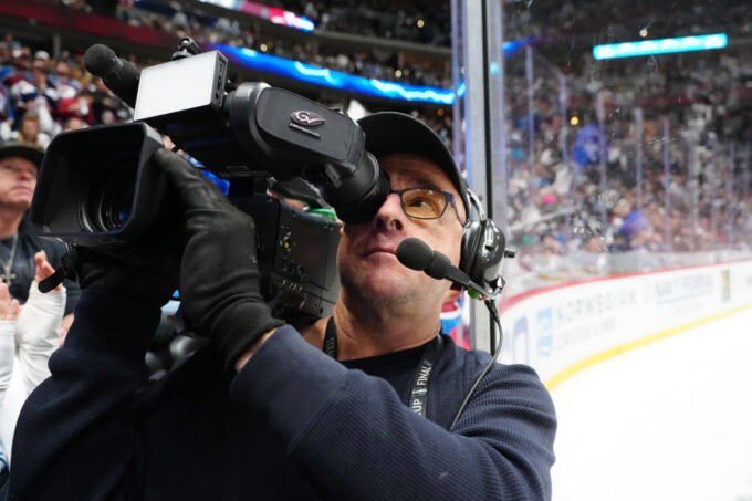 May 1, 2025; Denver, Colorado, USA; Altitude in house TV broadcaster Jim Huck films during the third period between the Dallas Stars against the Colorado Avalanchein game six of the first round of the 2025 Stanley Cup Playoffs at Ball Arena. Mandatory Credit: Ron Chenoy-Imagn Images