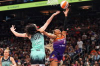 Sep 19, 2025; Phoenix, Arizona, USA; Phoenix Mercury forward Satou Sabally (0) shoots over New York Liberty forward Breanna Stewart (30) during the second half of game three of round one for the 2025 WNBA Playoffs at PHX Arena. Mandatory Credit: Joe Camporeale-Imagn Images