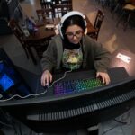 Sidney Plott plays an online computer game while waiting for a food order at the new Games and Grub. on Nov. 28, 2025.