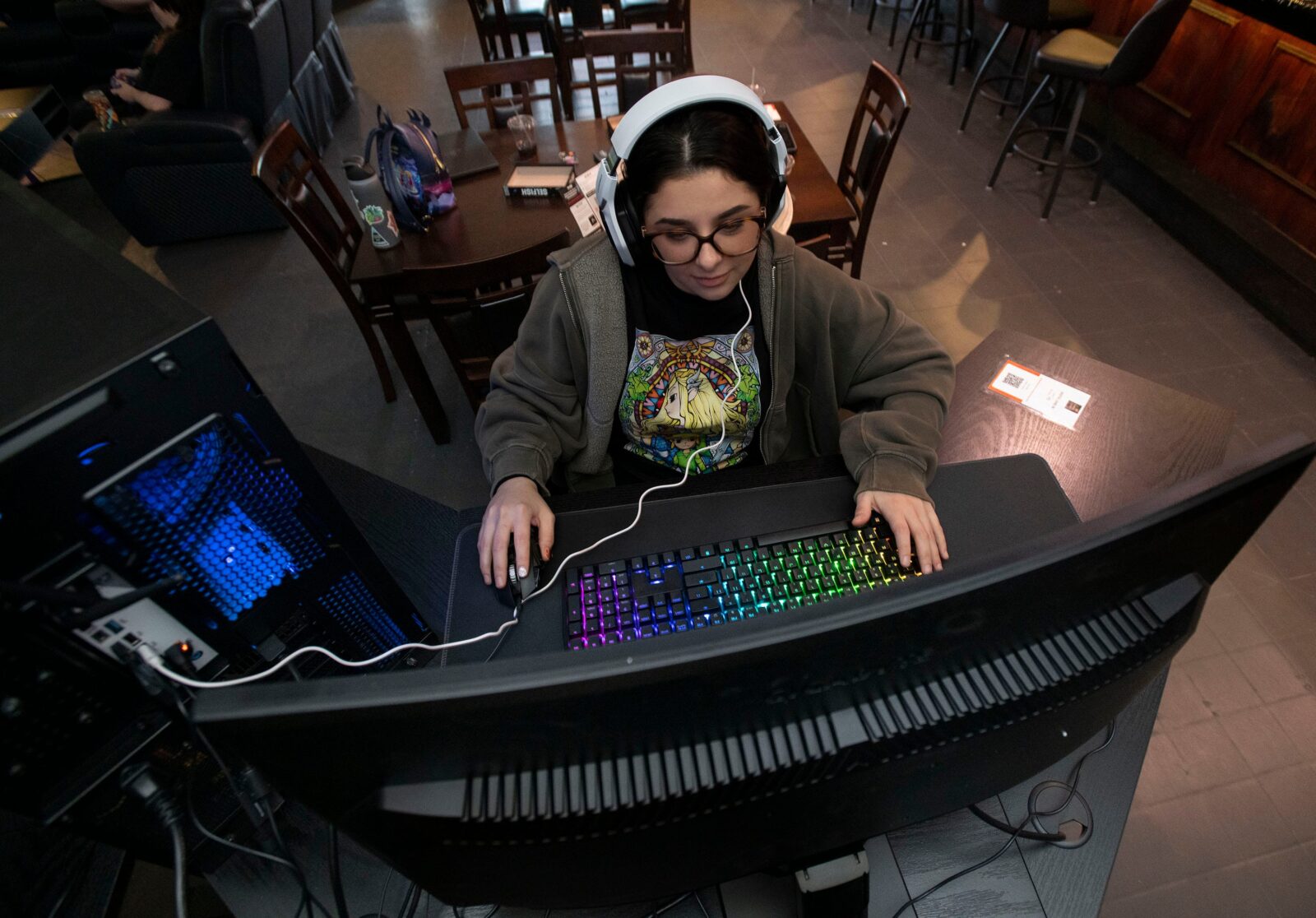Sidney Plott plays an online computer game while waiting for a food order at the new Games and Grub. on Nov. 28, 2025.