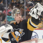 Dec 14, 2025; Pittsburgh, Pennsylvania, USA; Pittsburgh Penguins goalie Sergei Murashov (1) sprays water in the air against the Utah Mammoth during the second period at PPG Paints Arena.