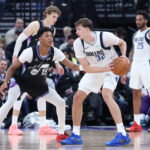 Dec 15, 2025; Salt Lake City, Utah, USA; Dallas Mavericks forward Cooper Flagg (32) holds the ball as Utah Jazz guard Ace Bailey (19) defends at Delta Center. Mandatory Credit: Rob Gray-Imagn Images
