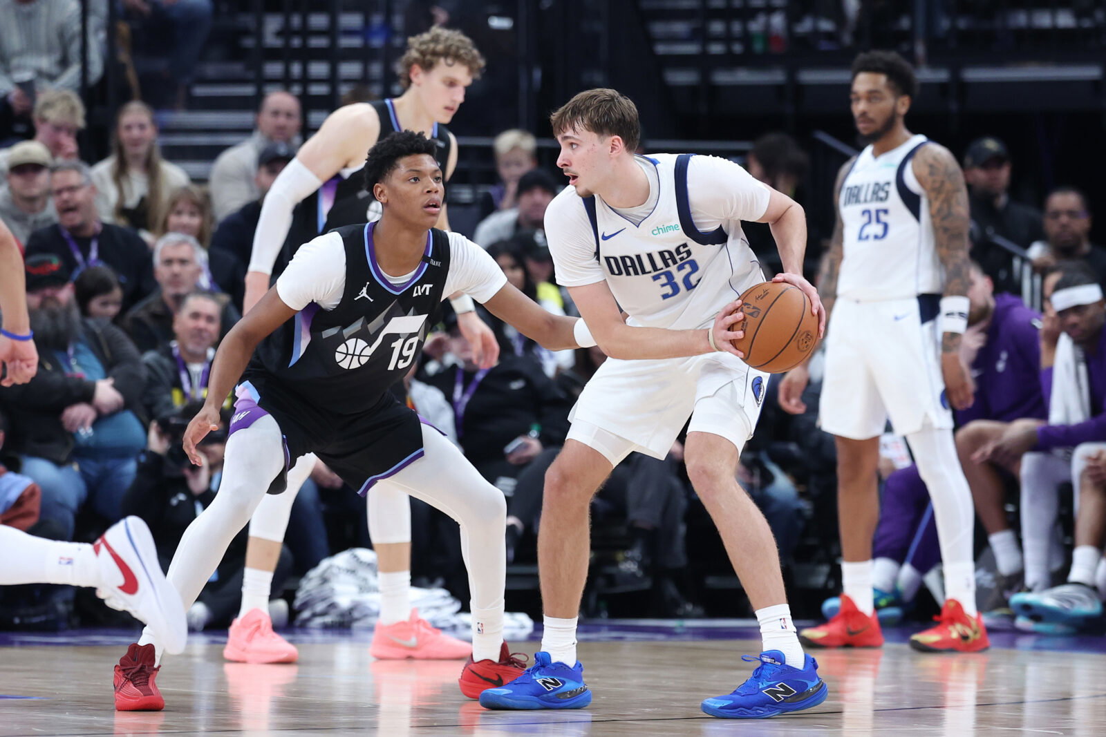 Dec 15, 2025; Salt Lake City, Utah, USA; Dallas Mavericks forward Cooper Flagg (32) holds the ball as Utah Jazz guard Ace Bailey (19) defends at Delta Center. Mandatory Credit: Rob Gray-Imagn Images