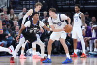 Dec 15, 2025; Salt Lake City, Utah, USA; Dallas Mavericks forward Cooper Flagg (32) holds the ball as Utah Jazz guard Ace Bailey (19) defends at Delta Center. Mandatory Credit: Rob Gray-Imagn Images