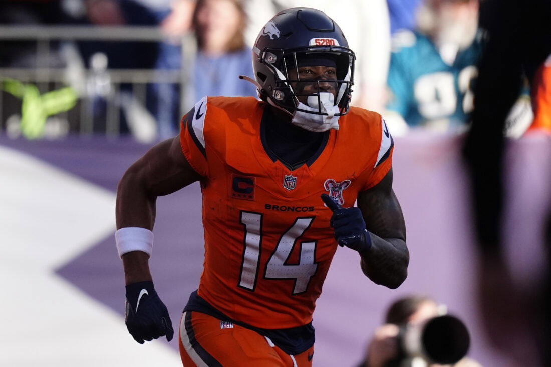 Dec 21, 2025; Denver, Colorado, USA; Denver Broncos wide receiver Courtland Sutton (14) reacts after scoring a touchdown against the Jacksonville Jaguars during the first half at Empower Field at Mile High. Mandatory Credit: Ron Chenoy-Imagn Images