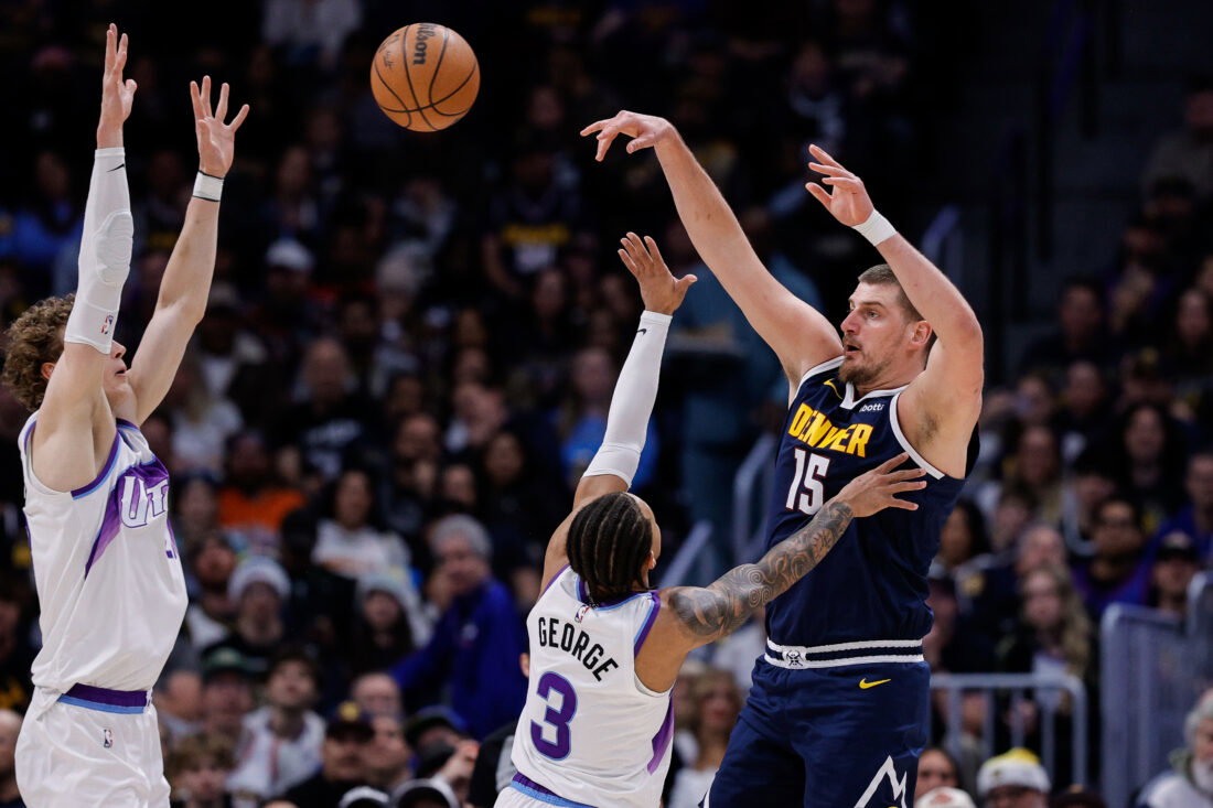 Dec 22, 2025; Denver, Colorado, USA; Denver Nuggets center Nikola Jokic (15) passes the ball as Utah Jazz guard Keyonte George (3) and forward Lauri Markkanen (23) defend in the second quarter at Ball Arena. Mandatory Credit: