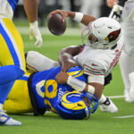 Jan 4, 2026; Inglewood, California, USA; Los Angeles Rams defensive end Desjuan Johnson (94) sacks Arizona Cardinals quarterback Jacoby Brissett (7) during the second half at SoFi Stadium. Mandatory Credit: Jayne Kamin-Oncea-Imagn Images