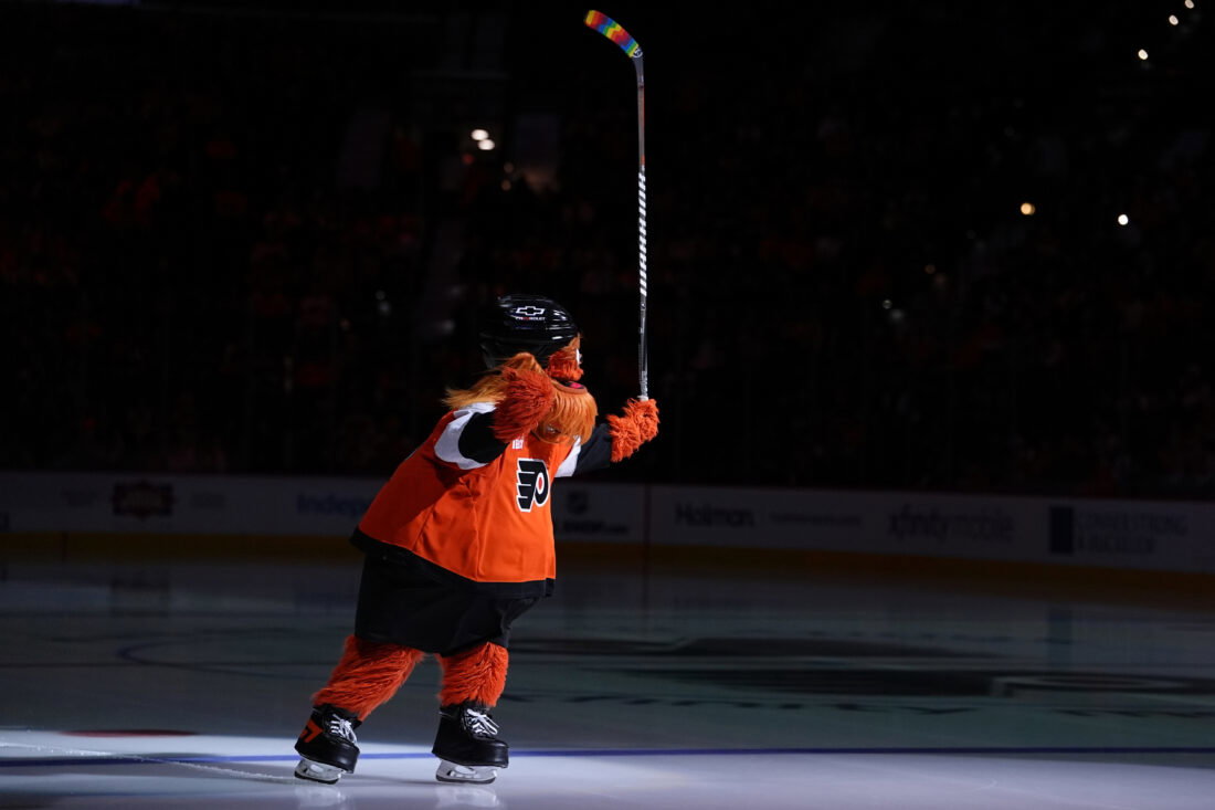 Jan 12, 2026; Philadelphia, Pennsylvania, USA; Philadelphia Flyers mascot Gritty entertains fans with rainbow stick tape for Pride Night before the game against the Tampa Bay Lightning at Xfinity Mobile Arena. Mandatory Credit: Kyle Ross-Imagn Images