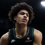 Feb 22, 2026; Minneapolis, Minnesota, USA; Minnesota Timberwolves forward Joan Beringer (19) looks on during the second half against the Philadelphia 76ers at Target Center.