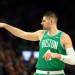 Feb 24, 2026; Phoenix, Arizona, USA; Boston Celtics center Nikola Vucevic (4) reacts against the Phoenix Suns in the first half at Mortgage Matchup Center.