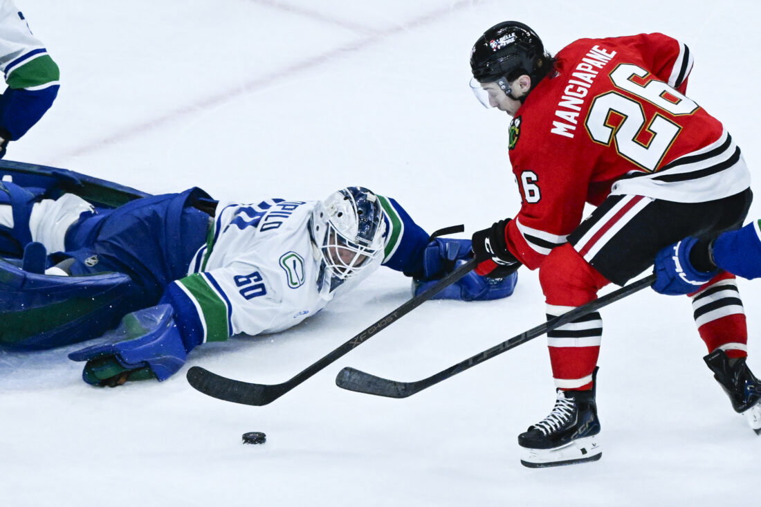 Mar 6, 2026; Chicago, Illinois, USA; Chicago Blackhawks left wing Andrew Mangiapane (26) shoots against Vancouver Canucks goaltender Nikita Tolopilo (60) during the third period at United Center. Mandatory Credit: