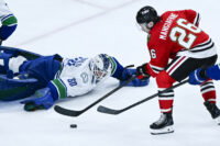 Mar 6, 2026; Chicago, Illinois, USA; Chicago Blackhawks left wing Andrew Mangiapane (26) shoots against Vancouver Canucks goaltender Nikita Tolopilo (60) during the third period at United Center. Mandatory Credit: