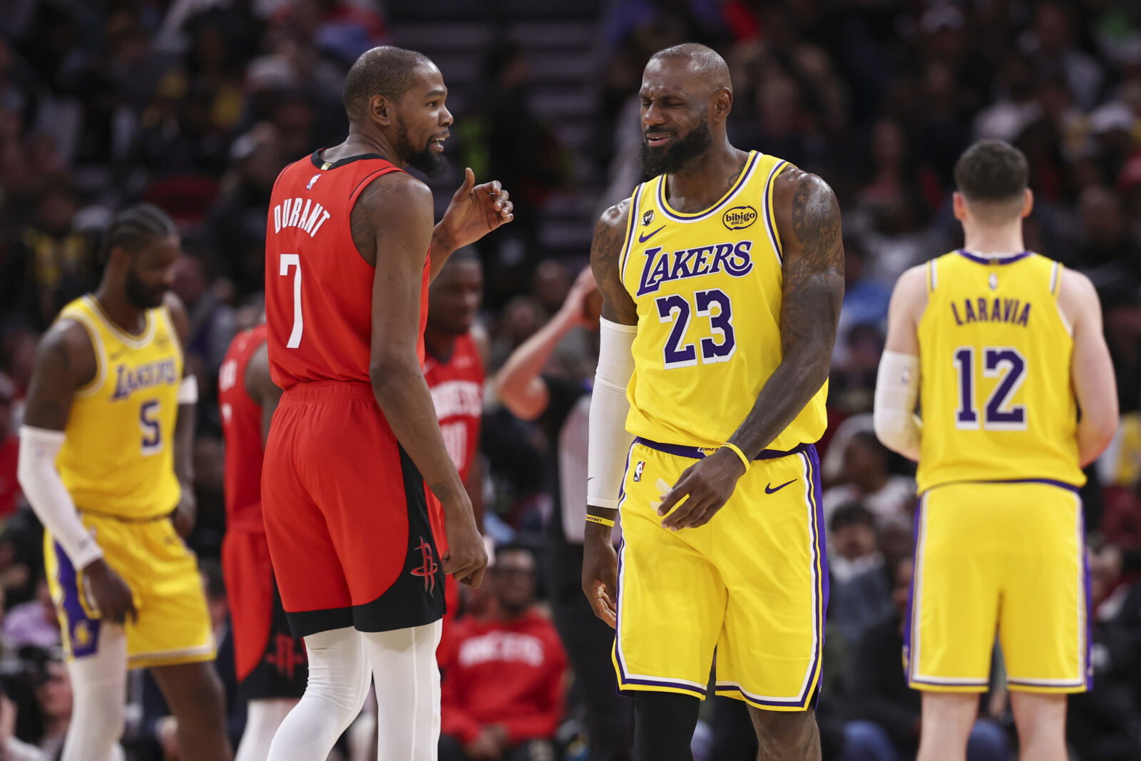 Mar 16, 2026; Houston, Texas, USA; Houston Rockets forward Kevin Durant (7) talks with Los Angeles Lakers forward LeBron James (23) on the court during the second quarter at Toyota Center.