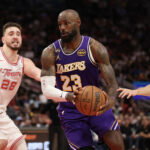 Mar 18, 2026; Houston, Texas, USA; Los Angeles Lakers forward LeBron James (23) splits the defense of Houston Rockets center Alperen Sengun (28) and guard Reed Sheppard (15) in the second half at Toyota Center. Mandatory Credit: Thomas Shea-Imagn Images