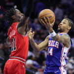 Mar 25, 2026; Philadelphia, Pennsylvania, USA; Philadelphia 76ers forward Dalen Terry (14) drives against Chicago Bulls forward Leonard Miller (11) during the fourth quarter at Xfinity Mobile Arena. Mandatory Credit:
