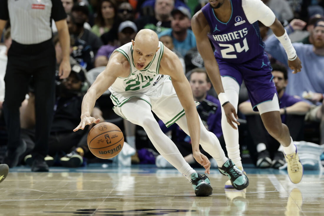 Mar 29, 2026; Charlotte, North Carolina, USA; Boston Celtics guard Jordan Walsh (27) dives after a loose ball during the second quarter against the Charlotte Hornets at Spectrum Center. Mandatory Credit: