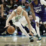 Mar 29, 2026; Charlotte, North Carolina, USA; Boston Celtics guard Jordan Walsh (27) dives after a loose ball during the second quarter against the Charlotte Hornets at Spectrum Center. Mandatory Credit: