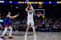 Mar 29, 2026; Denver, Colorado, USA; Golden State Warriors center Kristaps Porzingis (7) attempts a shot as Denver Nuggets guard Julian Strawther (3) defends in the second quarter at Ball Arena.