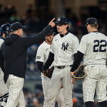 Apr 5, 2026; Bronx, New York, USA; New York Yankees manager Aaron Boone signals to the bullpen as pitcher Max Fried (54) leaves the game against the Miami Marlins during the seventh inning at Yankee Stadium. Mandatory Credit: John Jones-Imagn Images
