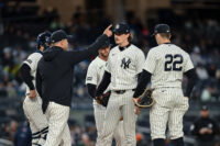 Apr 5, 2026; Bronx, New York, USA; New York Yankees manager Aaron Boone signals to the bullpen as pitcher Max Fried (54) leaves the game against the Miami Marlins during the seventh inning at Yankee Stadium. Mandatory Credit: John Jones-Imagn Images