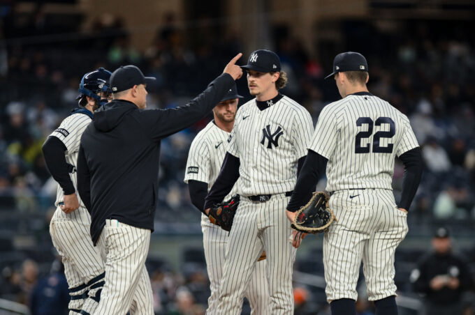 Apr 5, 2026; Bronx, New York, USA; New York Yankees manager Aaron Boone signals to the bullpen as pitcher Max Fried (54) leaves the game against the Miami Marlins during the seventh inning at Yankee Stadium. Mandatory Credit: John Jones-Imagn Images