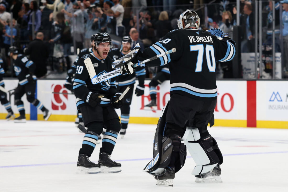 Apr 7, 2026; Salt Lake City, Utah, USA; Utah Mammoth defenseman Sean Durzi (50) and goaltender Karel Vejmelka (70) celebrate and overtime win over the against the Edmonton Oilers at Delta Center.