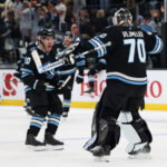Apr 7, 2026; Salt Lake City, Utah, USA; Utah Mammoth defenseman Sean Durzi (50) and goaltender Karel Vejmelka (70) celebrate and overtime win over the against the Edmonton Oilers at Delta Center.