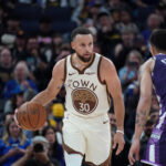 Apr 7, 2026; San Francisco, California, USA; Golden State Warriors guard Stephen Curry (30) dribbles upcourt while defended by Sacramento Kings guard Nique Clifford (5) in the fourth quarter at Chase Center.