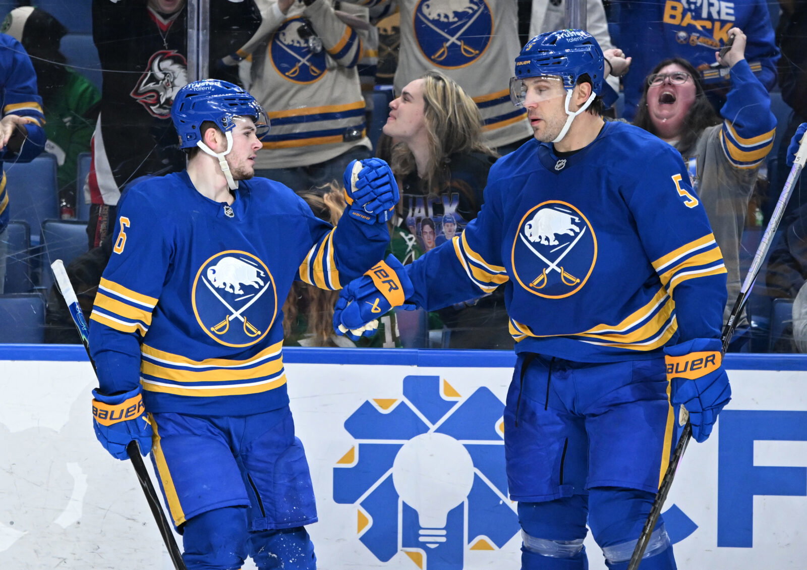 Apr 15, 2026; Buffalo, New York, USA; Buffalo Sabres left wing Zach Benson (6) celebrates scoring a goal against the Dallas Stars with defenseman Luke Schenn (5) in the second period at KeyBank Center. Mandatory Credit: