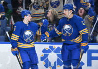 Apr 15, 2026; Buffalo, New York, USA; Buffalo Sabres left wing Zach Benson (6) celebrates scoring a goal against the Dallas Stars with defenseman Luke Schenn (5) in the second period at KeyBank Center. Mandatory Credit: