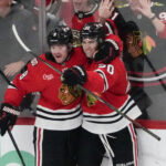 Apr 15, 2026; Chicago, Illinois, USA; Chicago Blackhawks center Ryan Greene (20) celebrates his goal against the San Jose Sharks with center Ryan Donato (8) during the third period at United Center. Mandatory Credit: