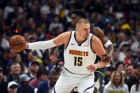 Apr 18, 2026; Denver, Colorado, USA; Denver Nuggets center Nikola Jokic (15) is fouled by Minnesota Timberwolves guard Anthony Edwards (5) as he handles the ball during the first half in game one of the first round of the 2026 NBA Playoffs at Ball Arena.