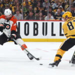 Apr 18, 2026; Pittsburgh, Pennsylvania, USA; Philadelphia Flyers center Sean Couturier (14) moves the puck against Pittsburgh Penguins center Sidney Crosby (87) during the second period in game one of the first round of the 2026 Stanley Cup Playoffs at PPG Paints Arena.