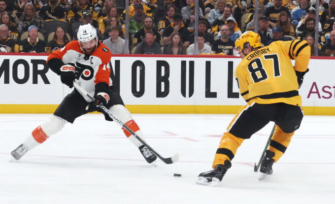 Apr 18, 2026; Pittsburgh, Pennsylvania, USA; Philadelphia Flyers center Sean Couturier (14) moves the puck against Pittsburgh Penguins center Sidney Crosby (87) during the second period in game one of the first round of the 2026 Stanley Cup Playoffs at PPG Paints Arena.