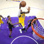 Apr 18, 2026; Los Angeles, California, USA; Los Angeles Lakers forward LeBron James (23) shoots the ball against Houston Rockets forward Jabari Smith Jr. (10) and guard Amen Thompson (1) in the second half during game one of the first round of the 2026 NBA Playoffs at Crypto.com Arena. Mandatory Credit: Kirby Lee-Imagn Images