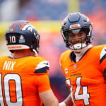Oct 27, 2024; Denver, Colorado, USA; Denver Broncos quarterback Bo Nix (10) and wide receiver Courtland Sutton (14) before the game against the Carolina Panthers at Empower Field at Mile High. Mandatory Credit: Ron Chenoy-Imagn Images