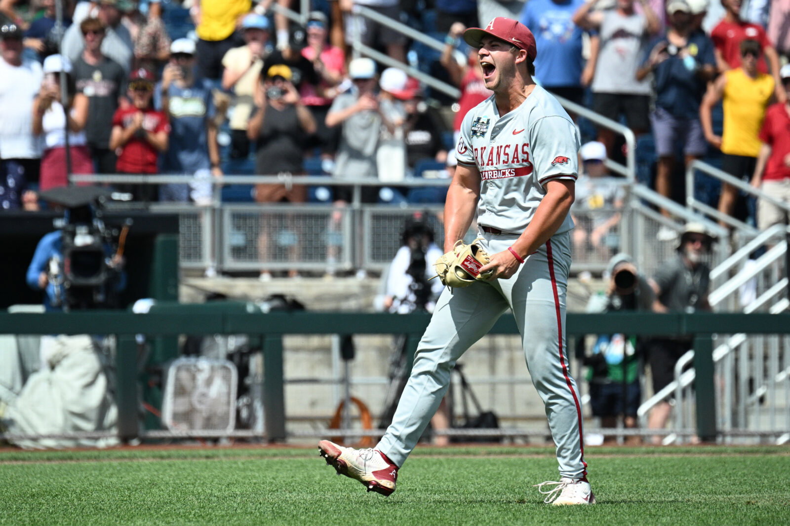Jun 16, 2025; Omaha, Neb, USA; Arkansas Razorbacks starting pitcher Gage Wood (14) celebrates completing a no hitter against the Murray State Racers at Charles Schwab Field. Mandatory Credit: Steven Branscombe-Imagn Images